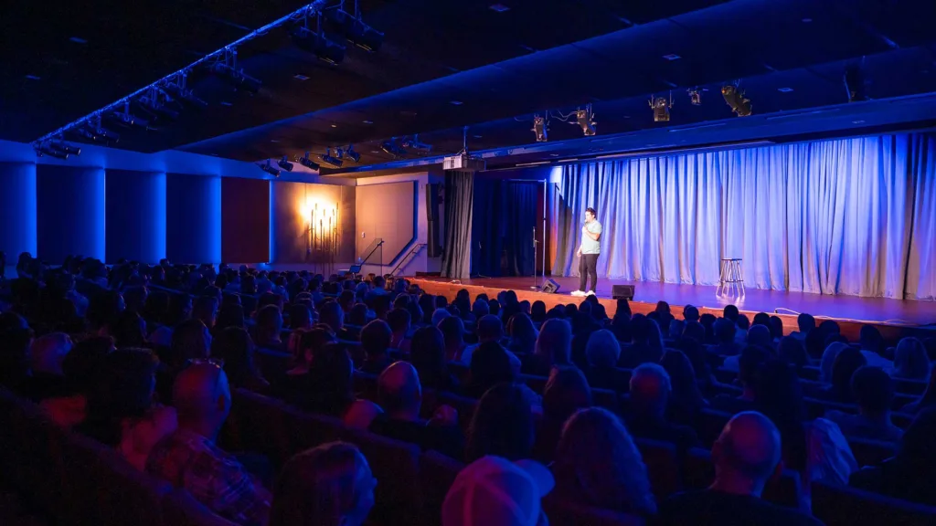 Comedian Jared Freid performs for an audience inside the The Hub at Temple Beth Am. Photo by Douglas Garland